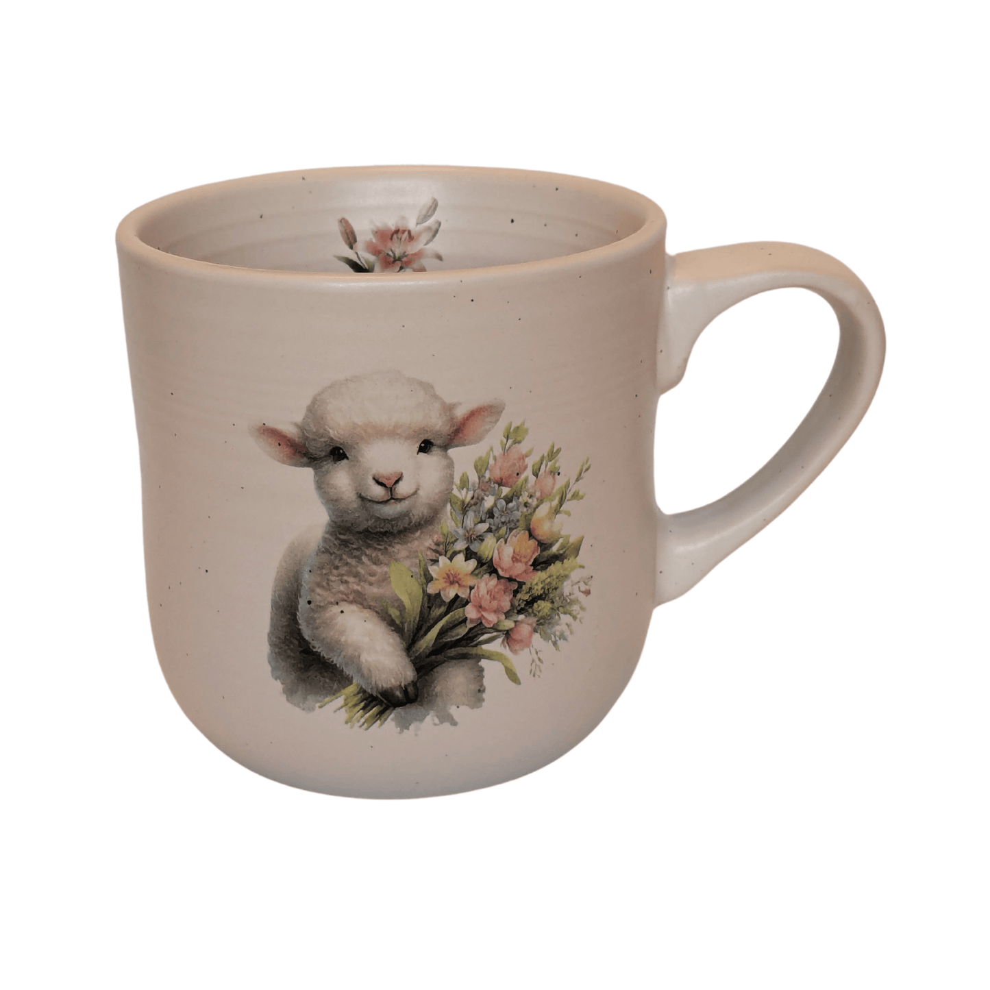 A stoneware mug with an image of a lamb holding a bunch of flowers and a small lily motif on the inner mug.